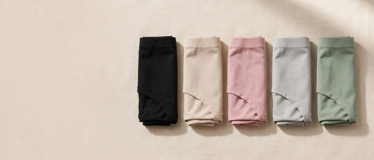 Folded leakproof period underwear in five colors on beige background - sinceshe homepage hero